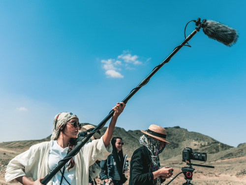 Students filming in the desert in Saudi Arabia