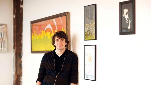 Male Graphic Design student at Champlain College in the Champlain Art Gallery which is site to numerous AIGA events