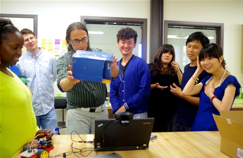 Professor Al Larsen demonstrating Ming Hu's software, digital bongo drums activated by the color blue.