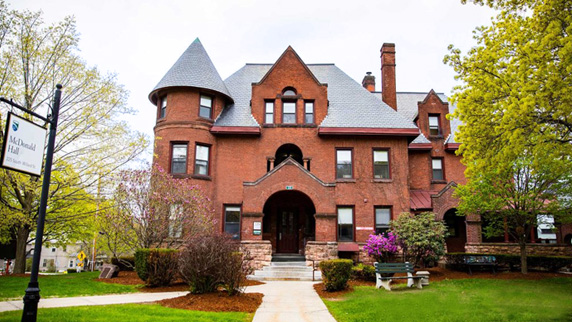 Front view of MacDonald Hall, a Victorian-era mansion residence hall
