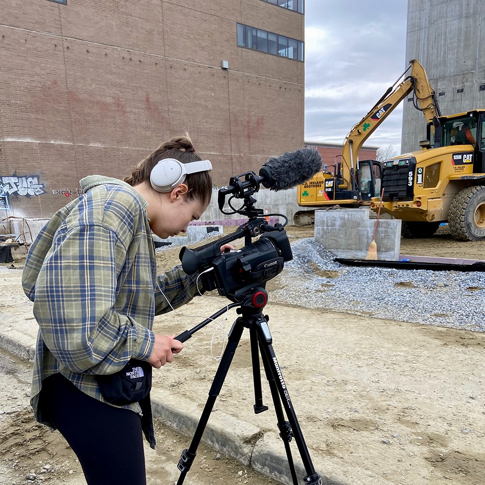 Student recording video in the contruction site.