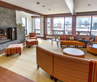 Common room, which features a fireplace and comfy furniture, in an upper-year res hall