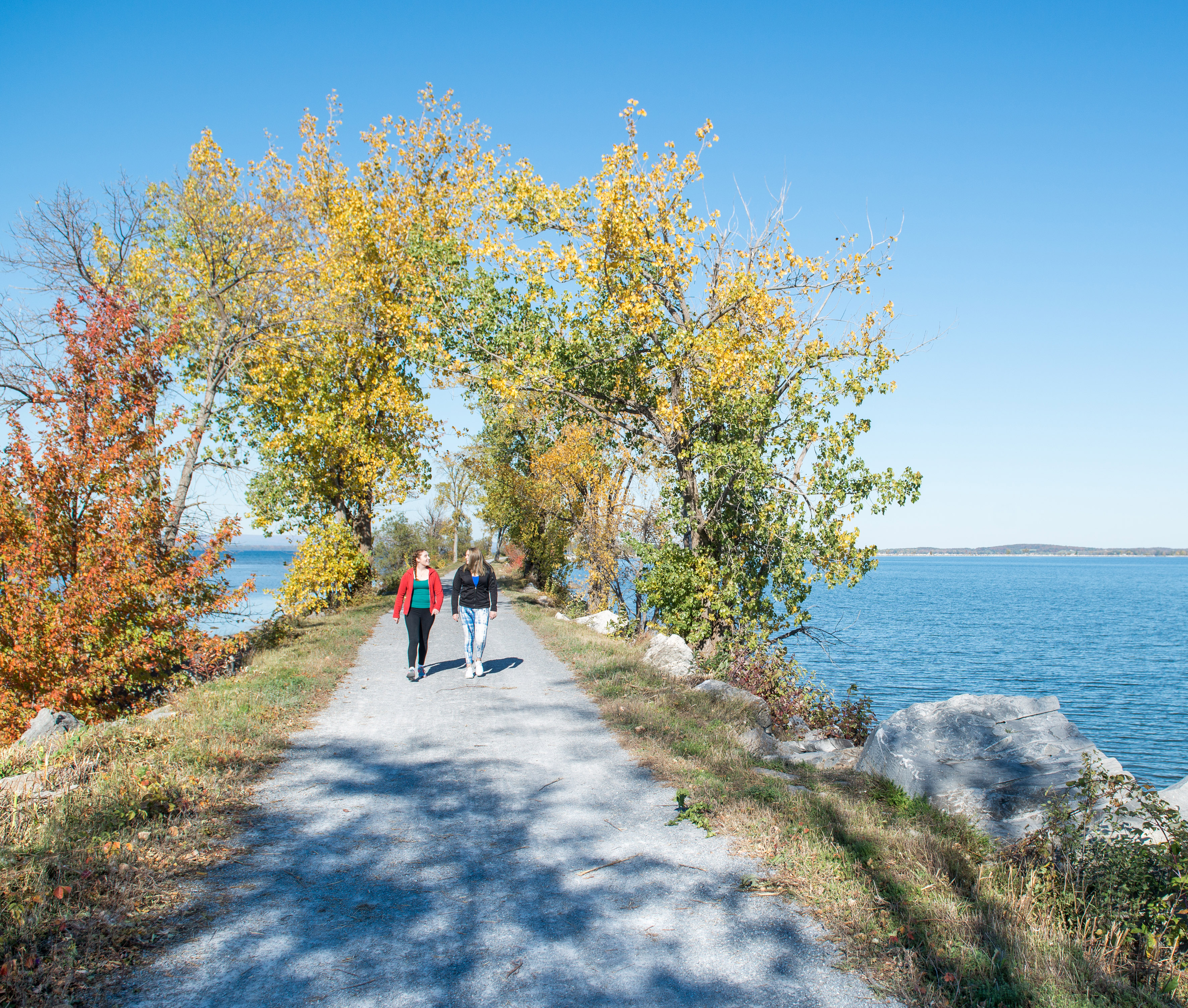 Students walking along the Burlington Bike Path, with Lake Champlain on both sides