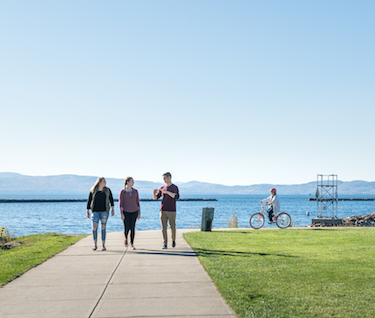 Students walking by the waterfront of Burlington, Vermont on a sunny day.