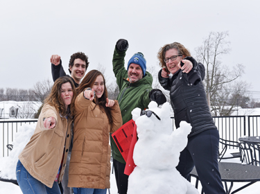 Staff and students with beaver snow sculpture