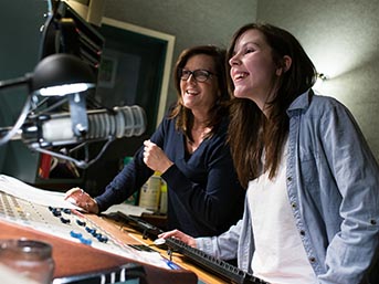 A faculty member works with a student in the Audio Lab