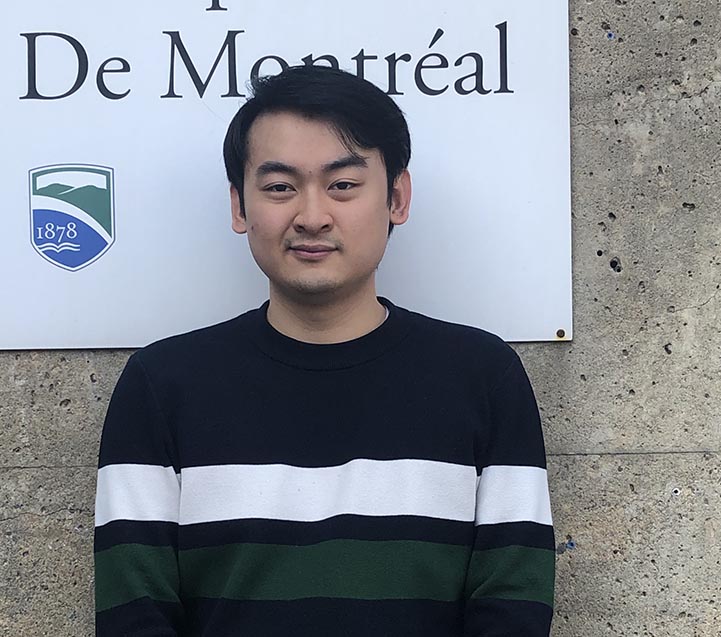 Champlain student Raymond Zheng stands in front of the Champlain College Montreal Campus sign