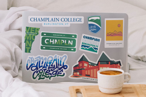 Laptop covered with Champlain College stickers
