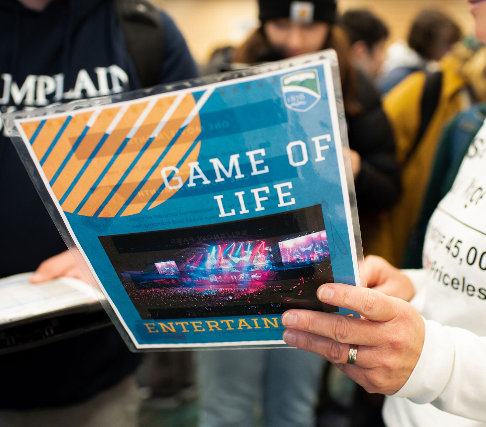 Two people collaborating and looking at a flyer that says "Game of Life"