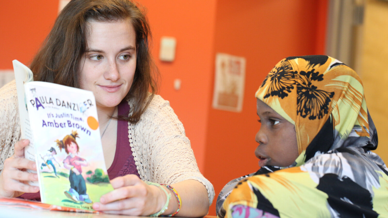 young adult reads with a child