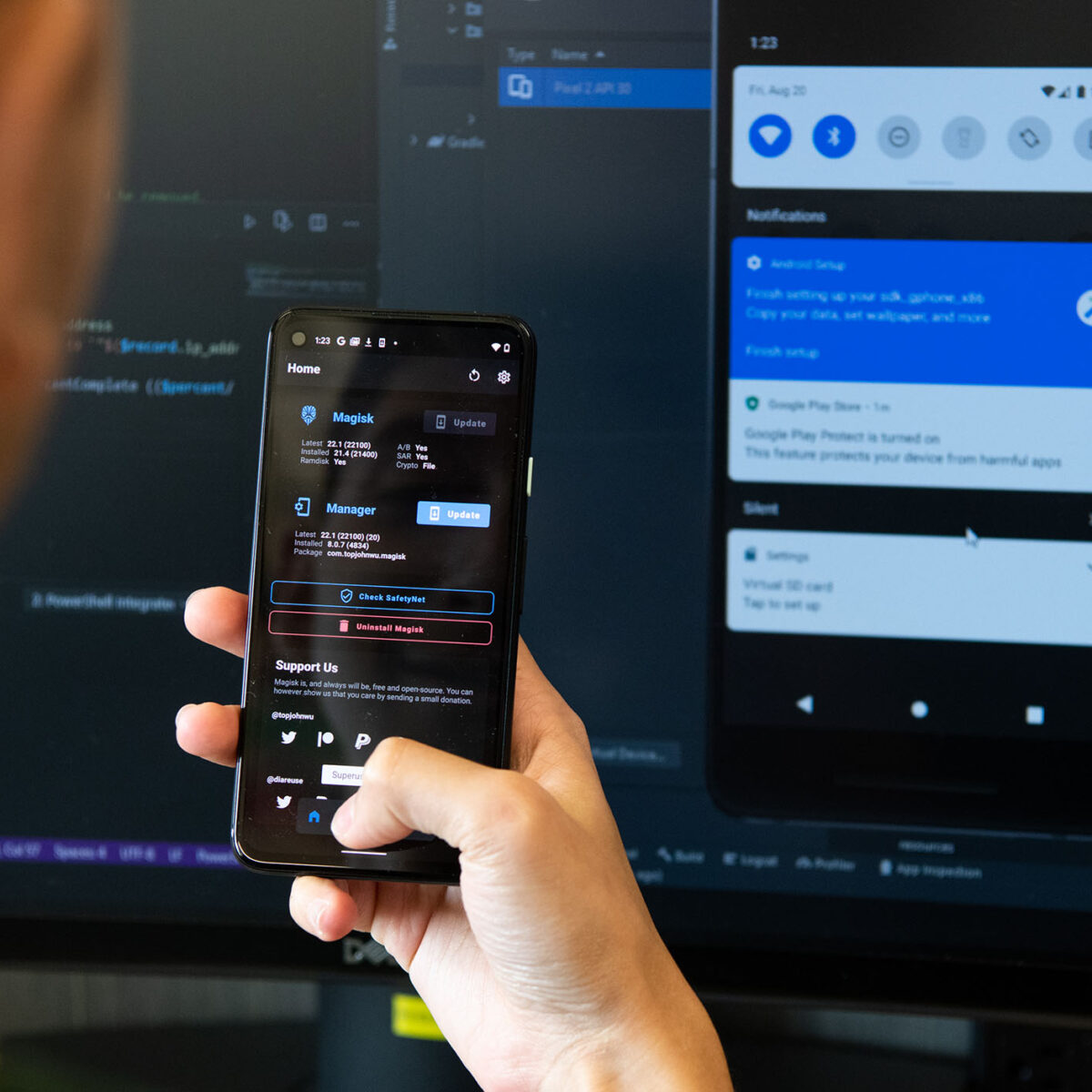 a cybersecurity student checks a mobile app and the computer code