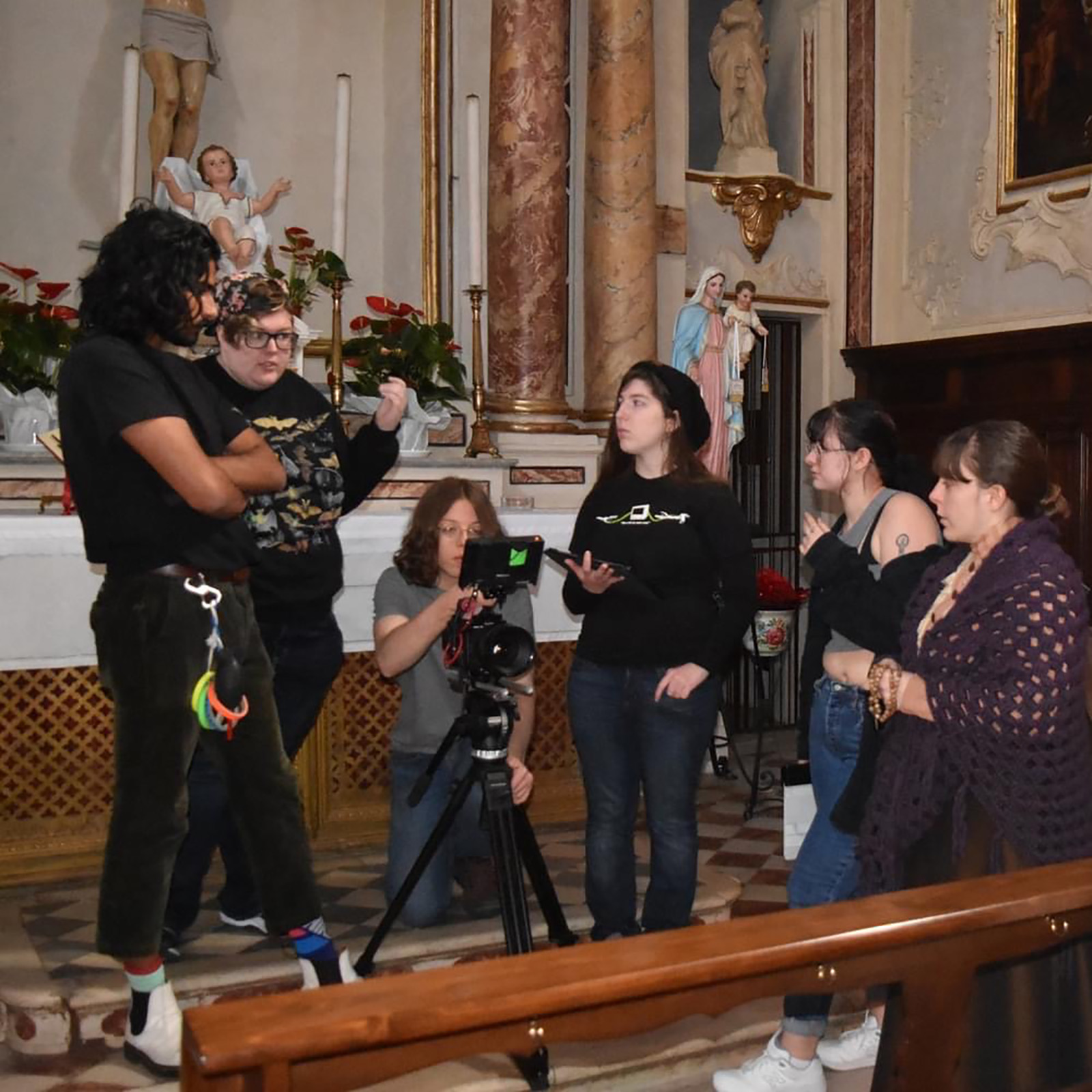 fil student sin Italy filming in a church