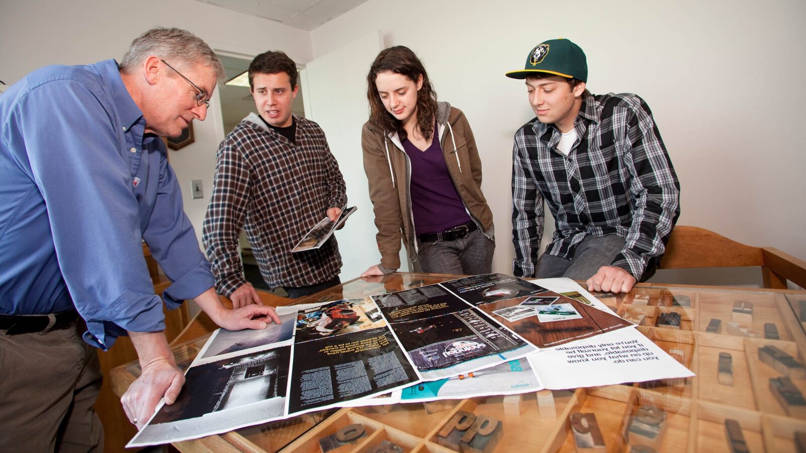 CCM Students Reviewing printer proof at Queen City Printers with Alan Schillhammer