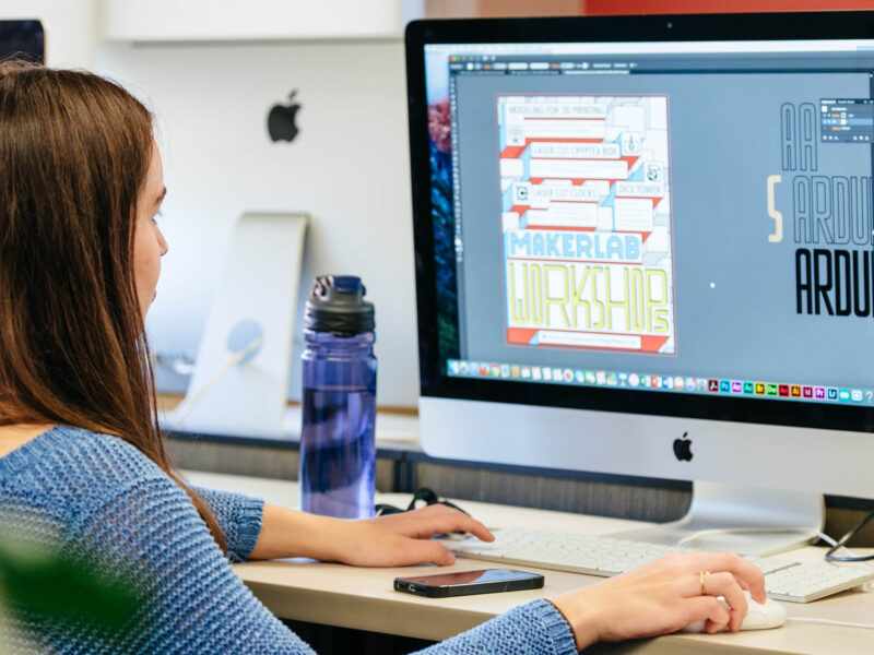 student layouts out a design on the computer