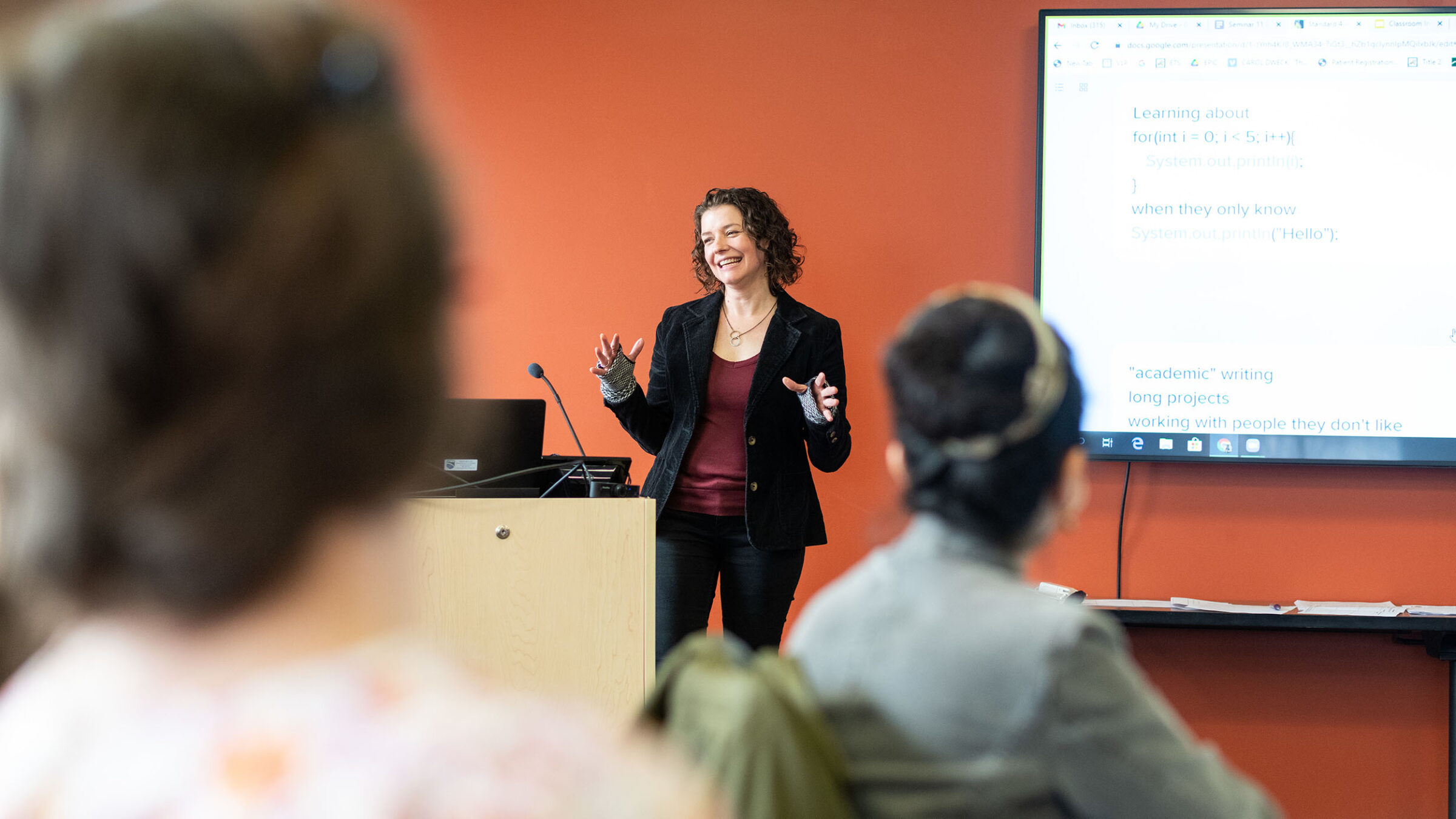 TAP professor standing at the front of a class, giving a presentation