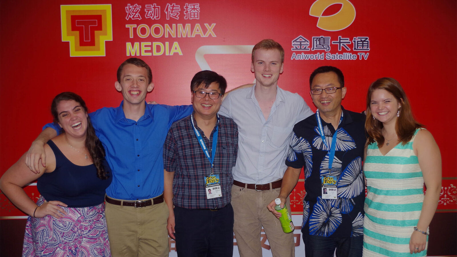 a group of students posing with members of an animation studio they worked with in shanghai