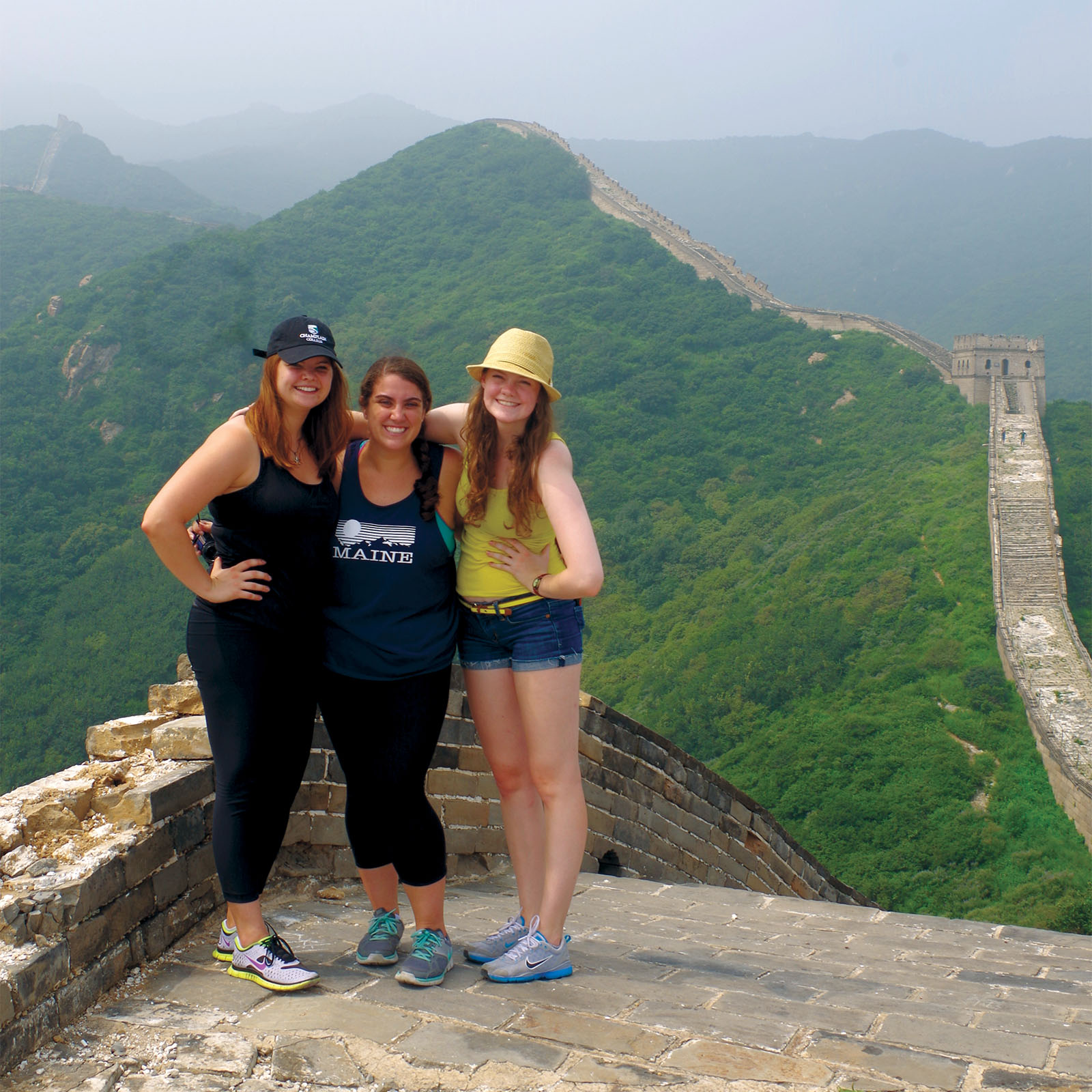abroad students posing for a photo atop the great wall of china
