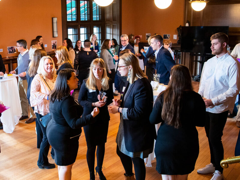 A room full of business professionals networking