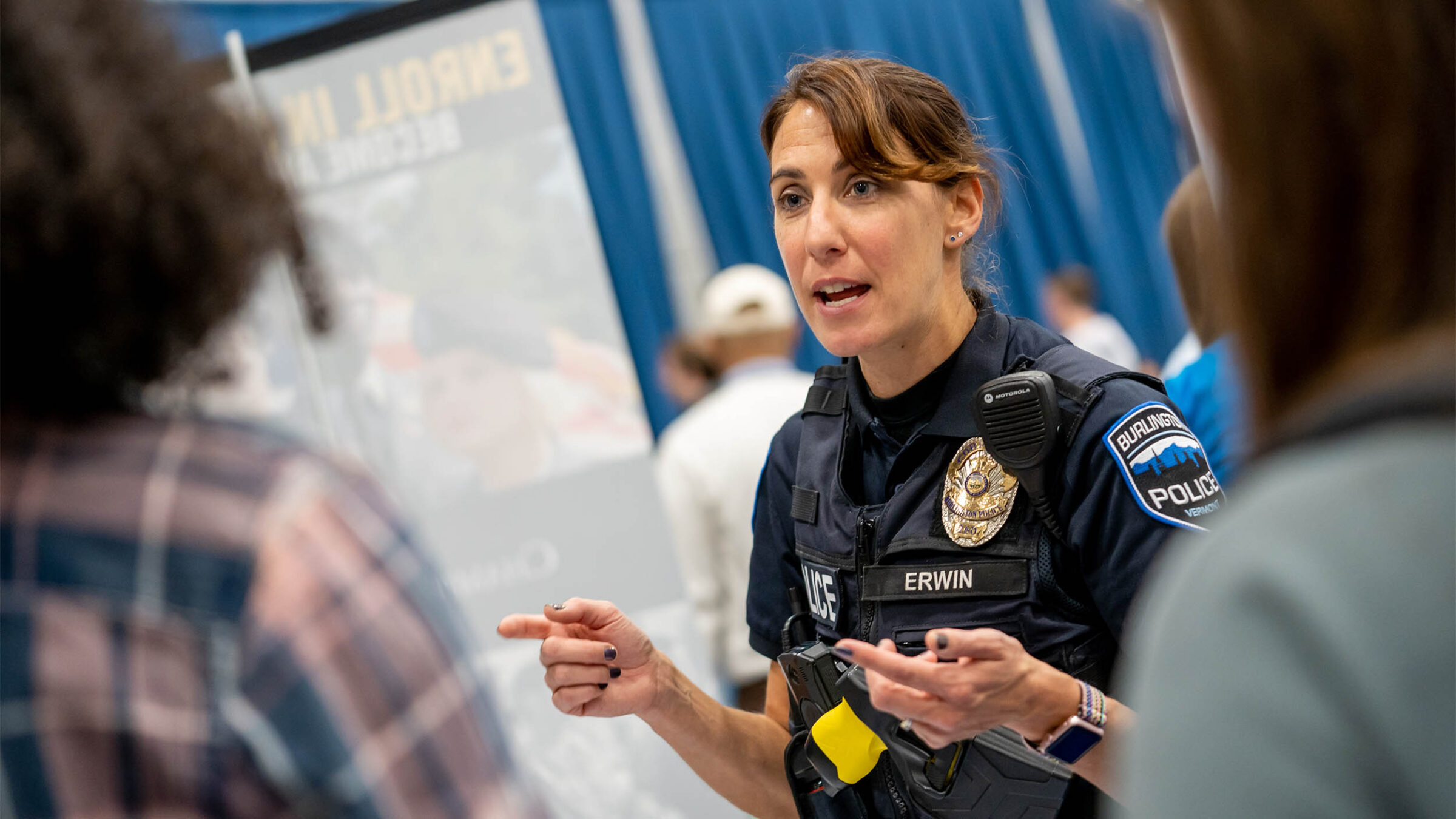 a police officer speaks to students at a career fair