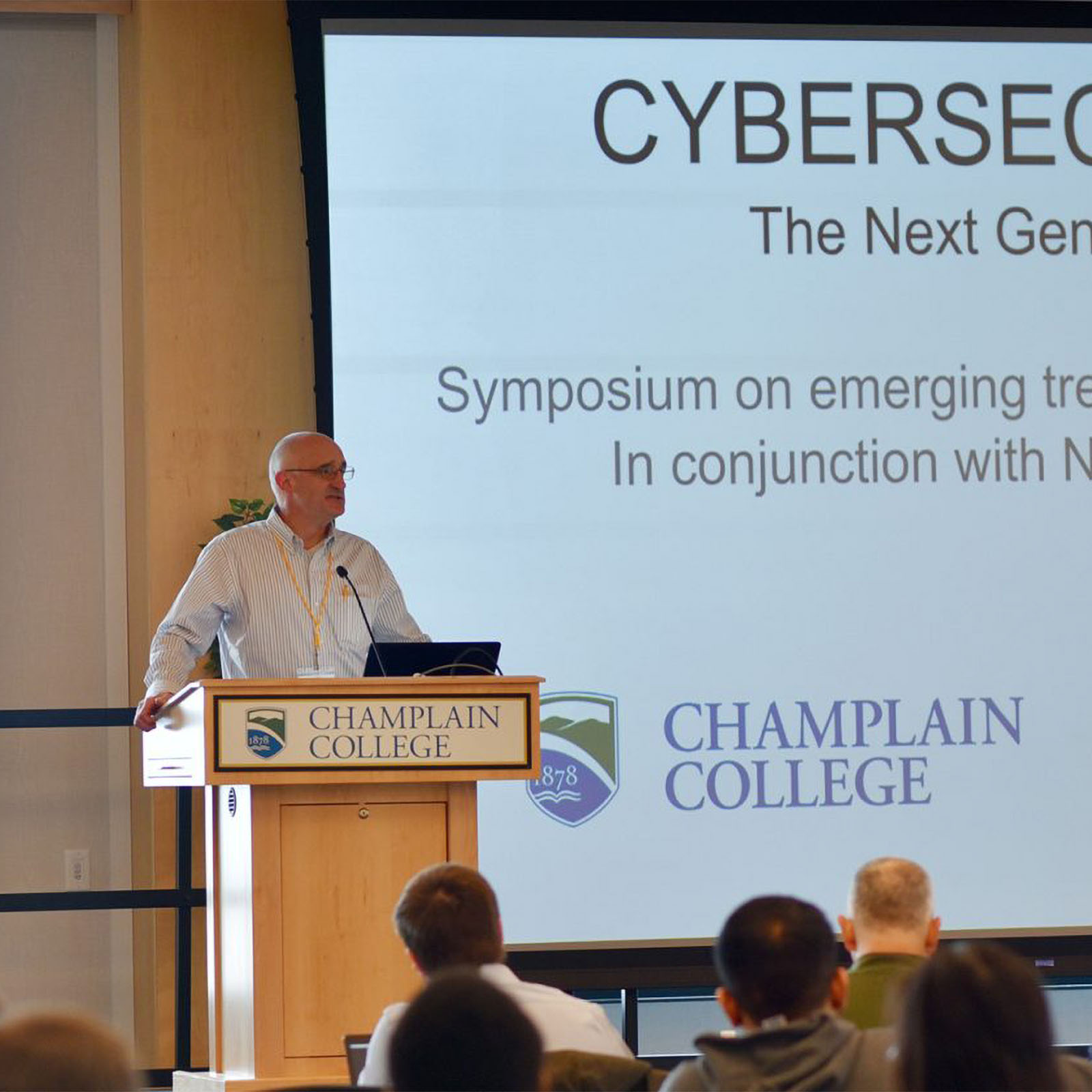 scott stevens delivering a speech at a cyber security conference in the champlain room