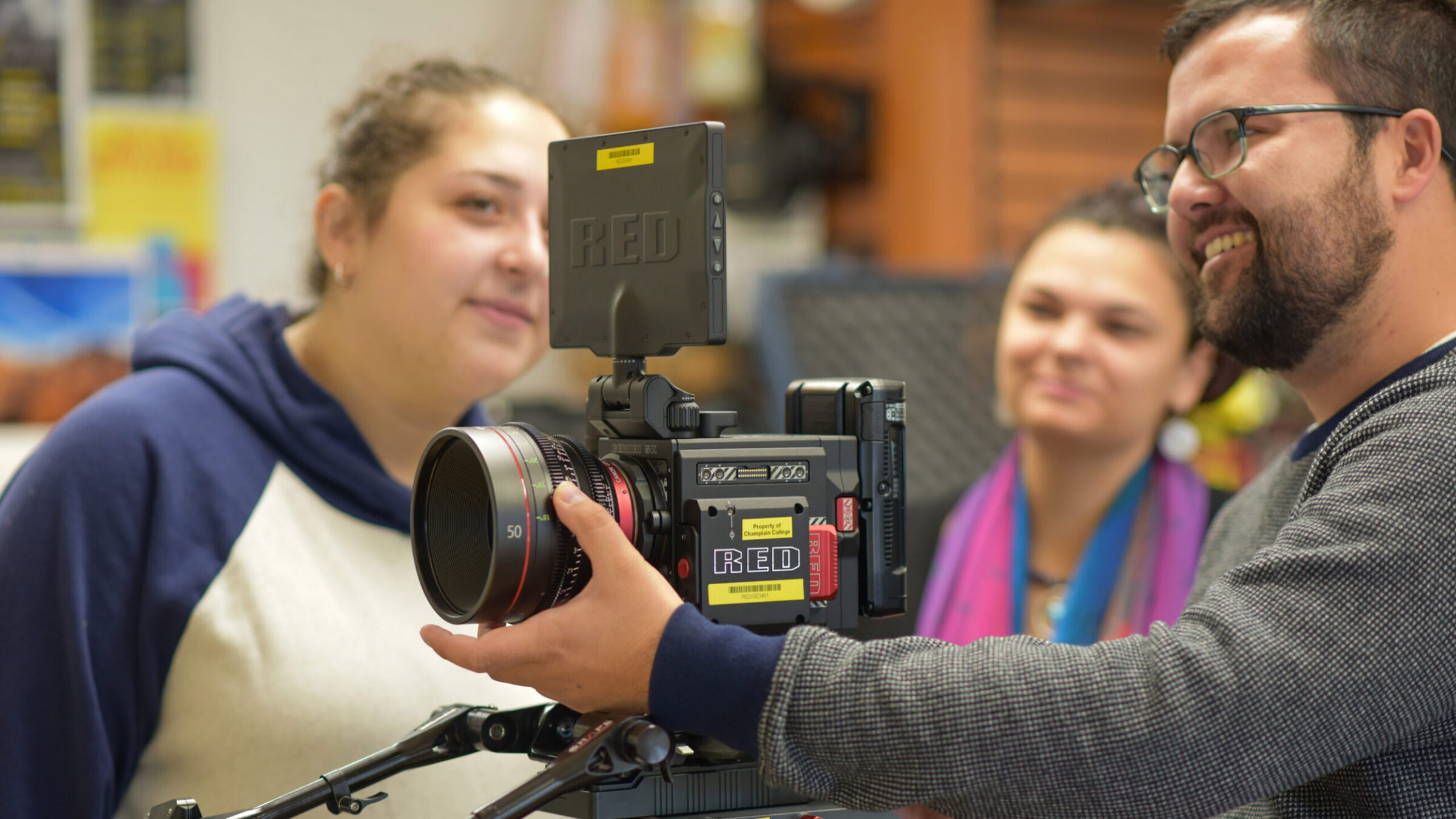 a professor shows two students a "red" camera