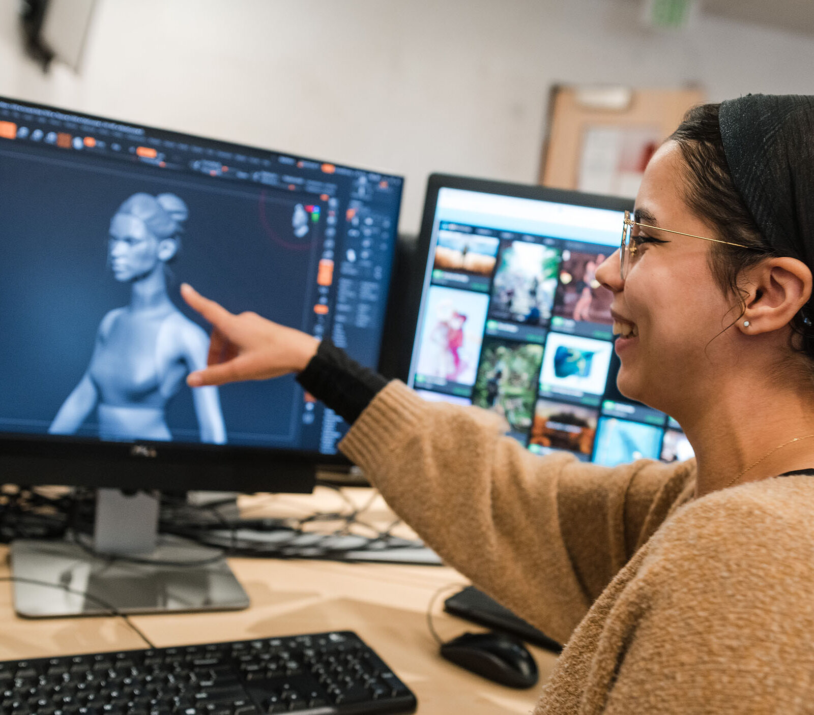 game art student pointing at a character model design on their screen