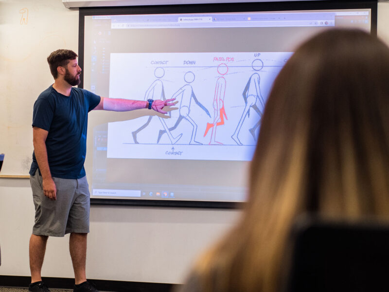professor instructing students how to animate a walk cycle