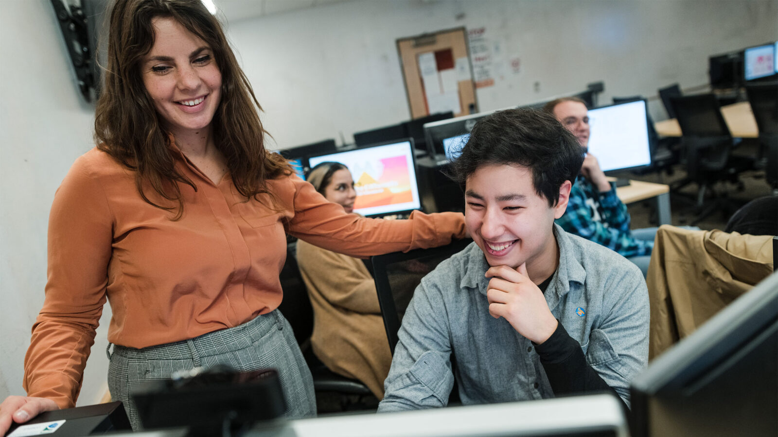 a game business professor and student collaborate over a digital project