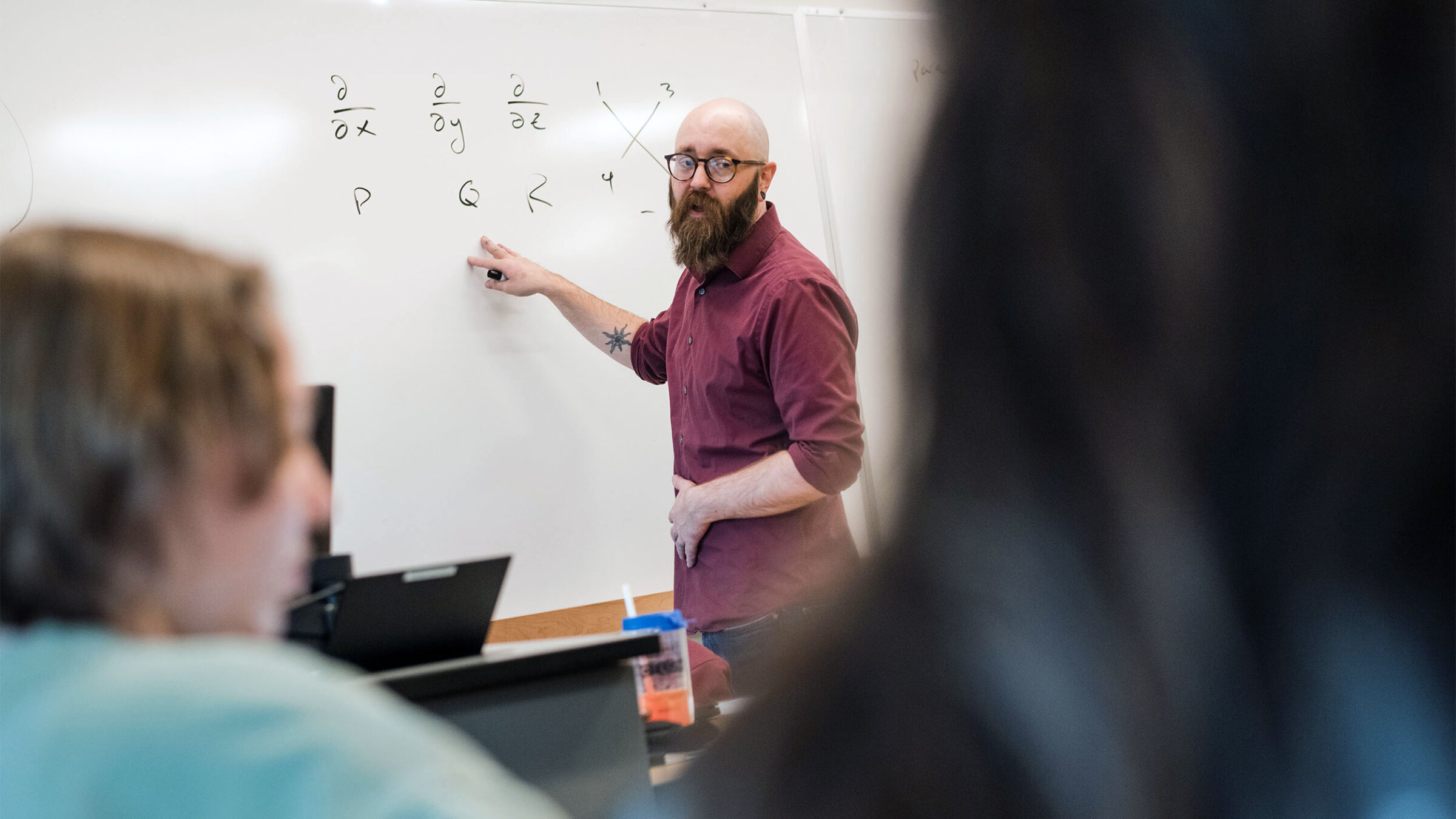 professor writing math on a white board
