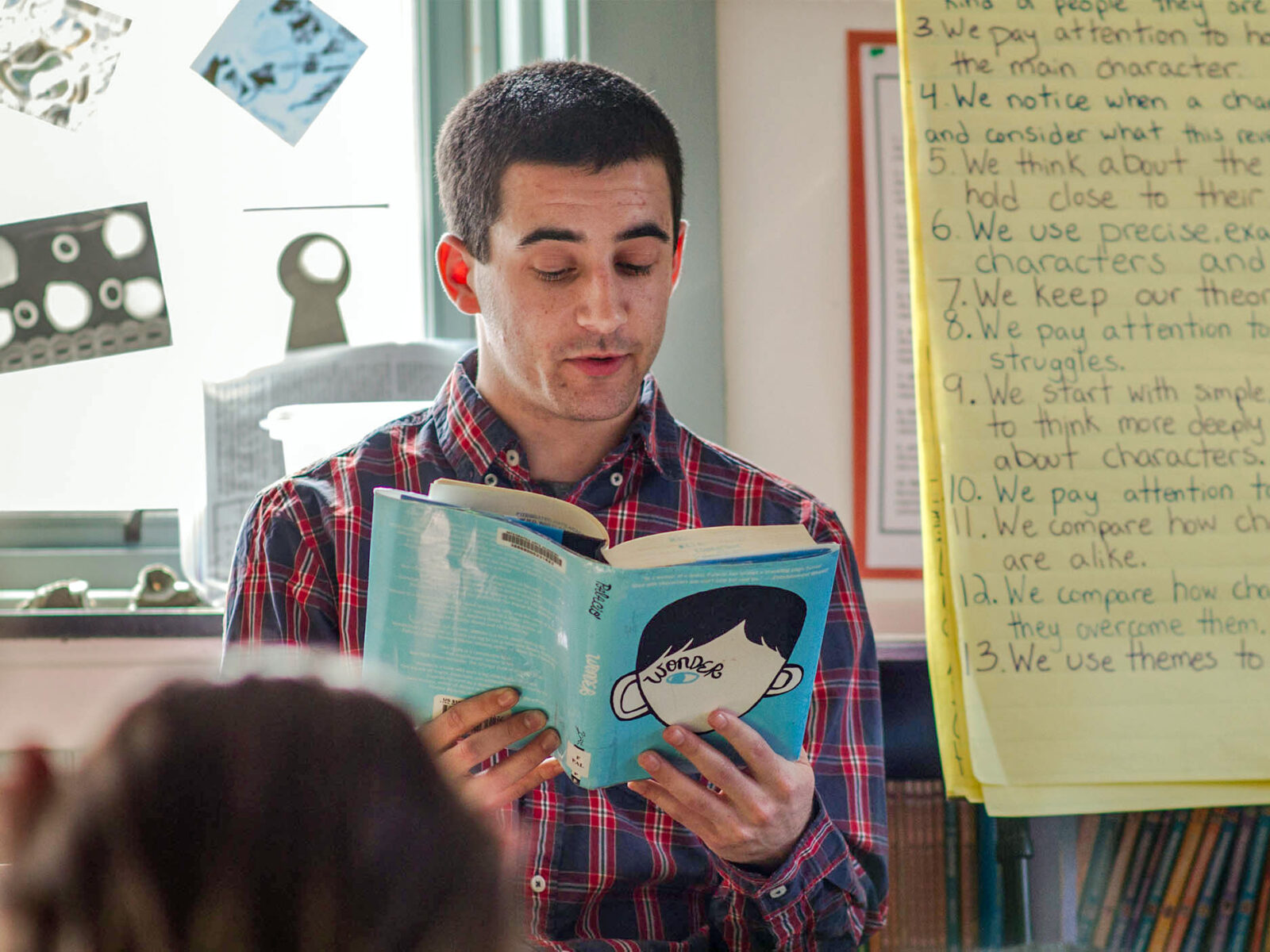 student teacher reads to children in a classroom