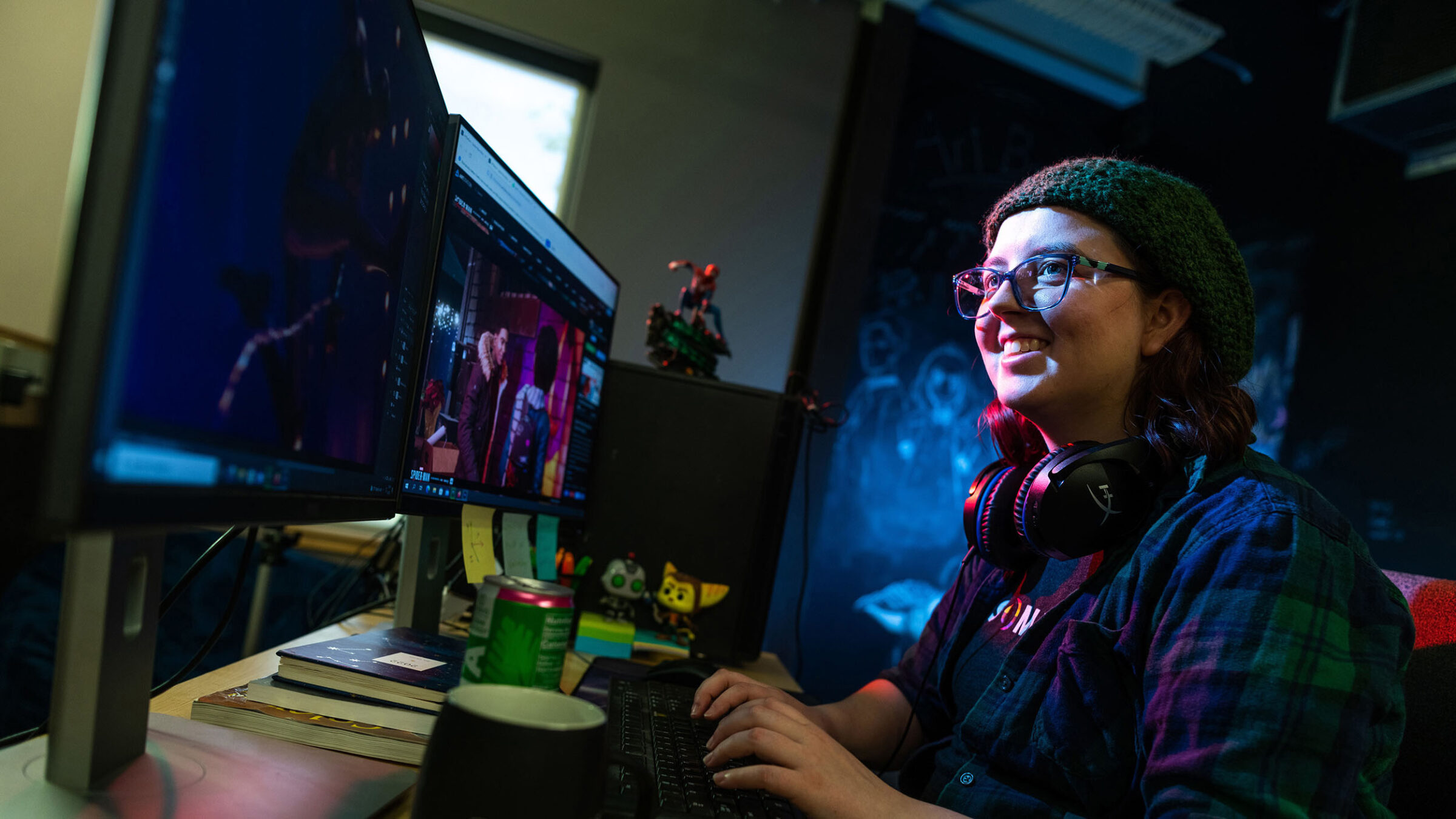 Game art student smiling at screen while working on a project
