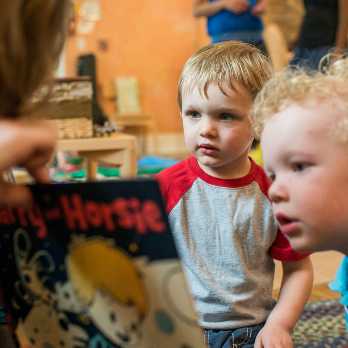 teacher reading to two small children