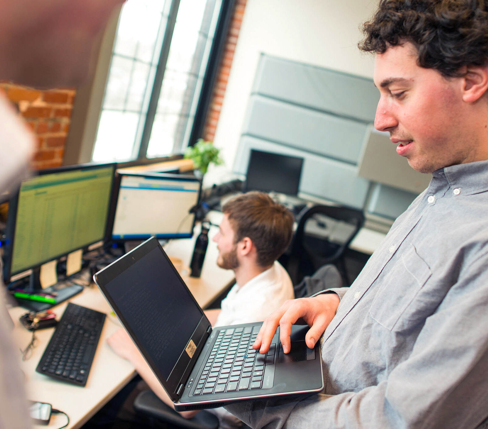 a computer science major working on a laptop in a professional environment