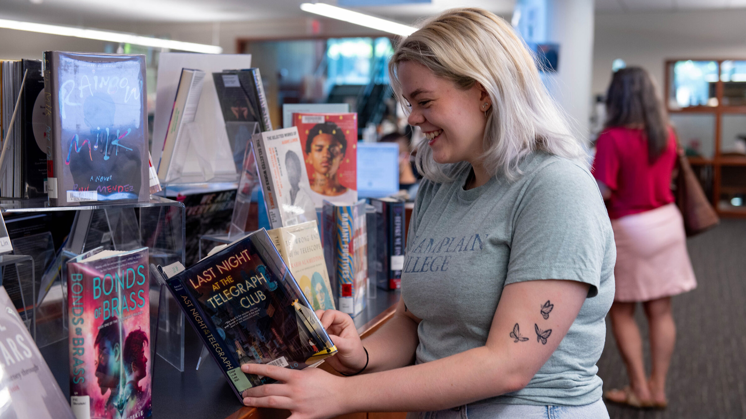 student chooses a book from a display