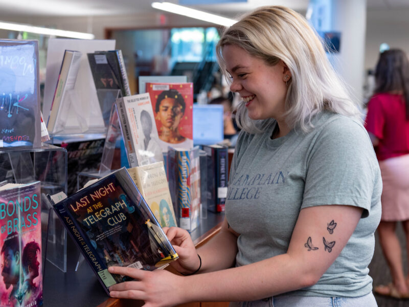 student chooses a book from a display