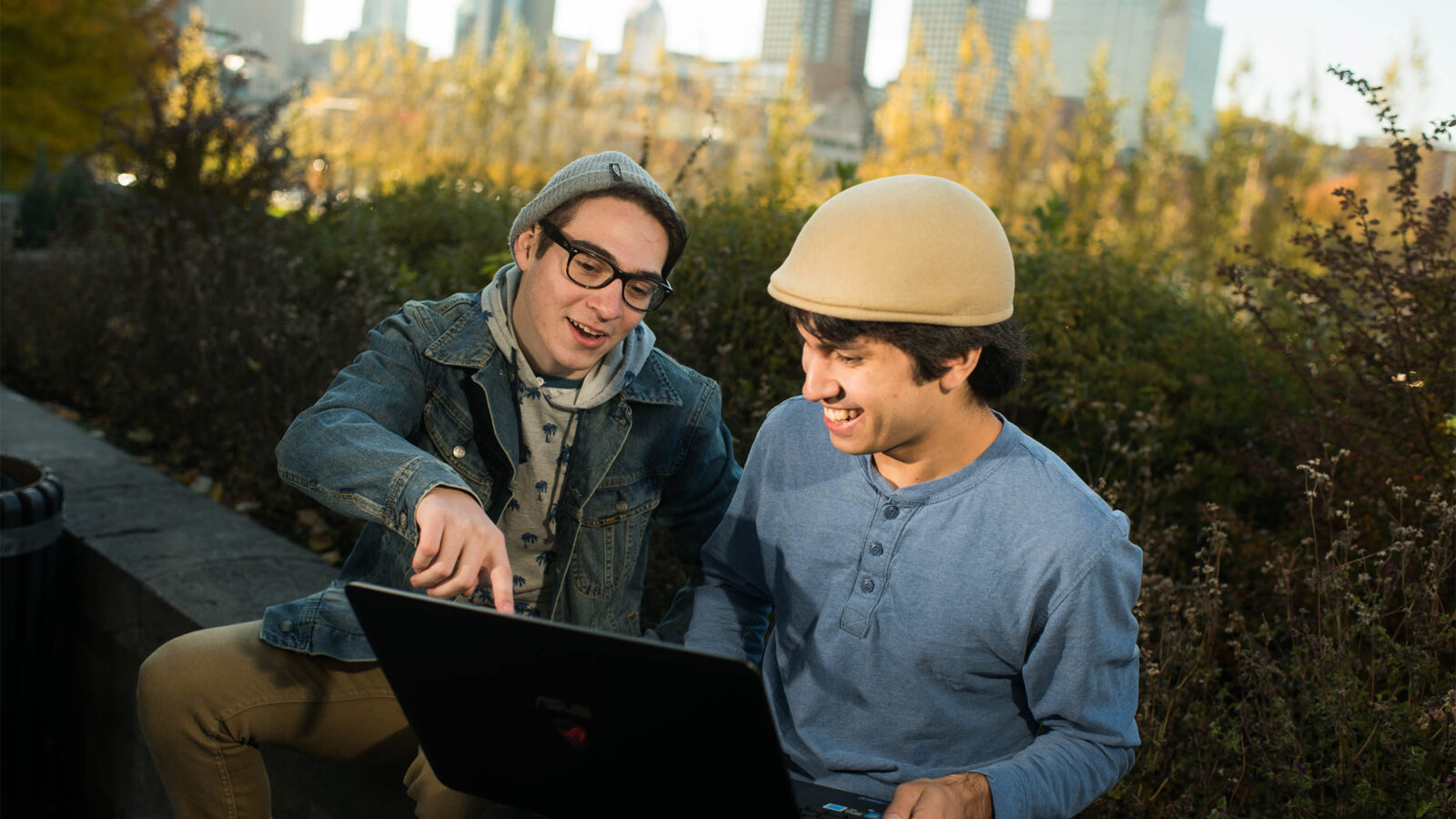 two champlain students abroad in montreal, looking at a laptop