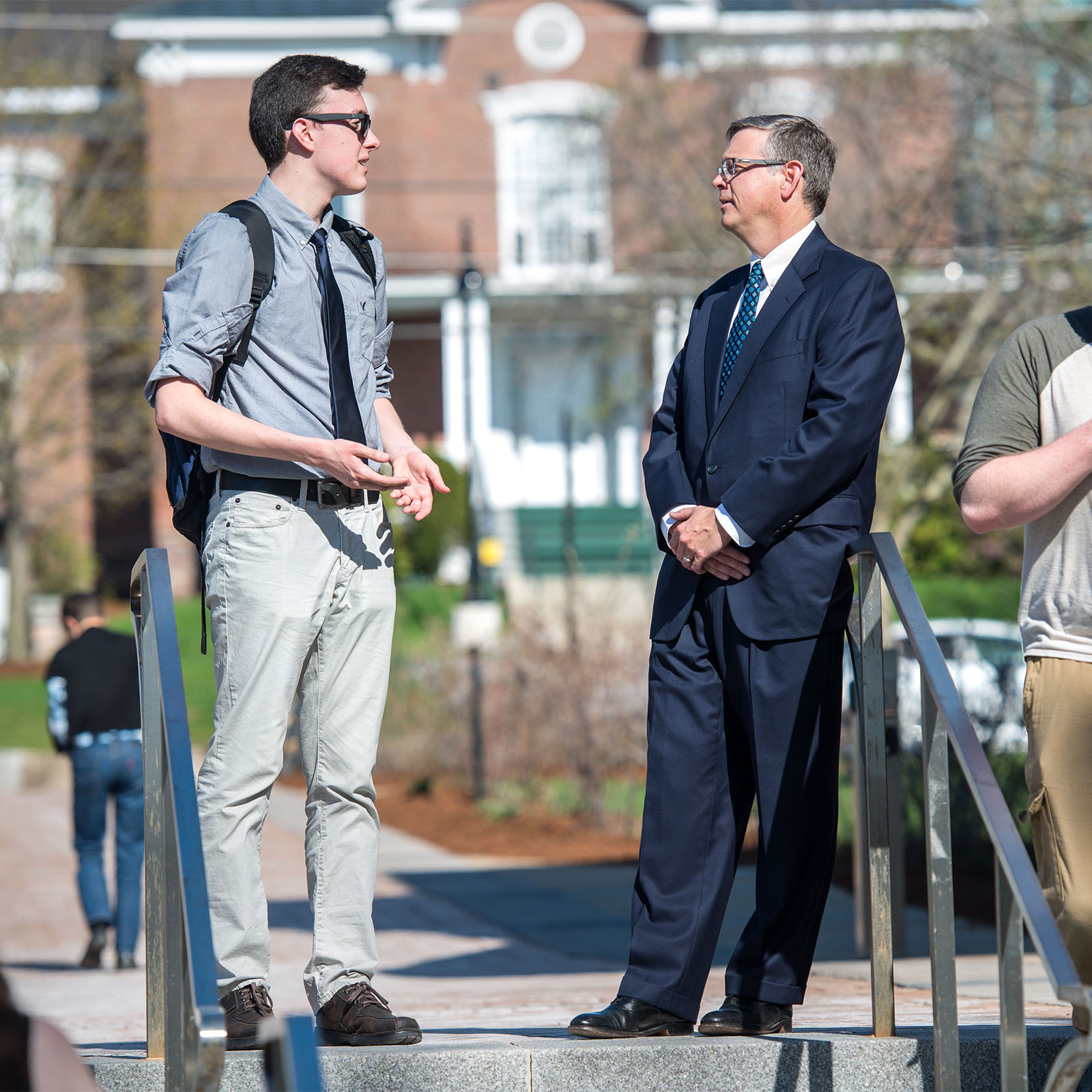 a student sharing a conversation outside with the Director of the Center for Financial Literacy at Champlain College, John Pelletier