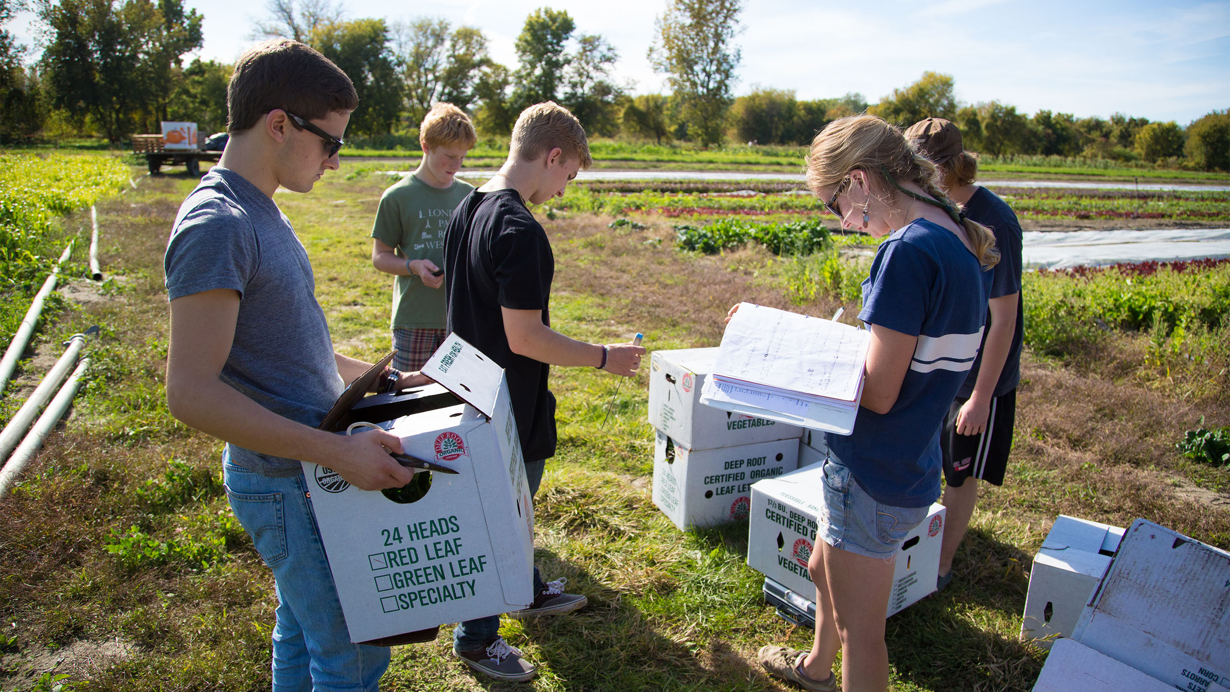 new graduate gives the camera a thumbs up and a smile