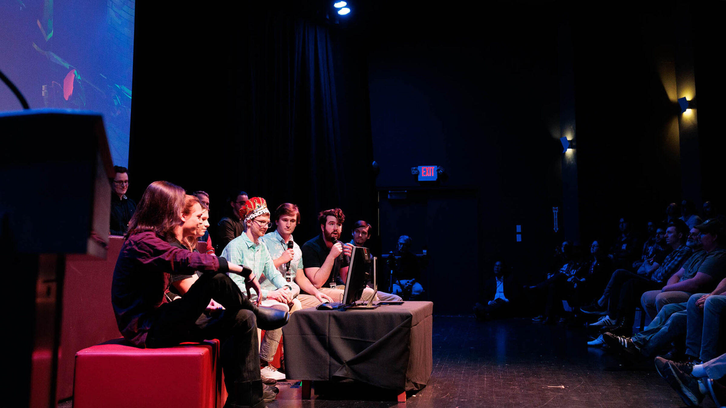 a group of game studio students unveiling their new game at the senior game show