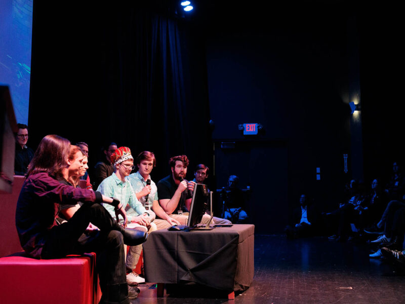 a group of game studio students unveiling their new game at the senior game show