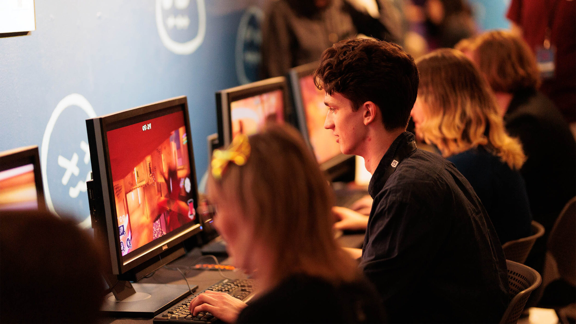 a group of individuals testing out the student games from the 2023 senior game show