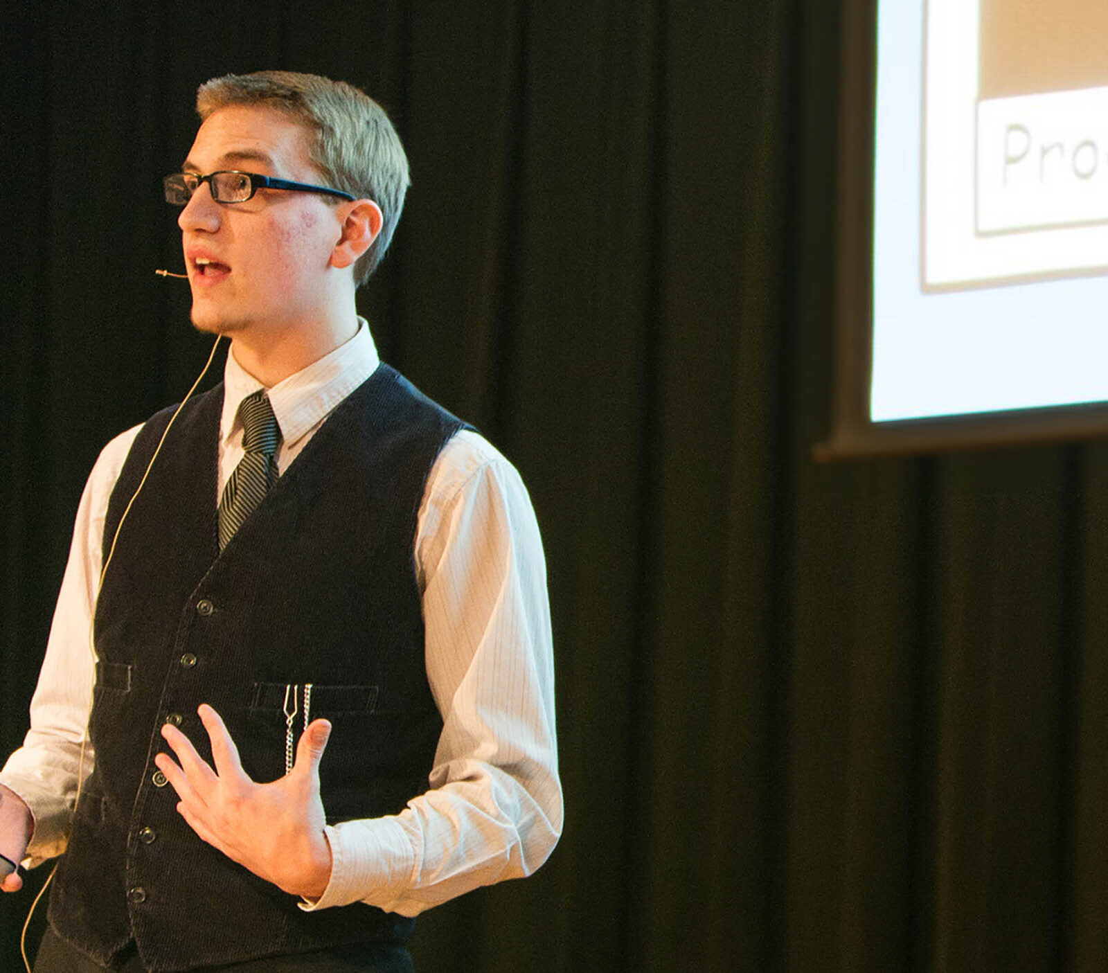 a game business student delivering a game presentation at a large event