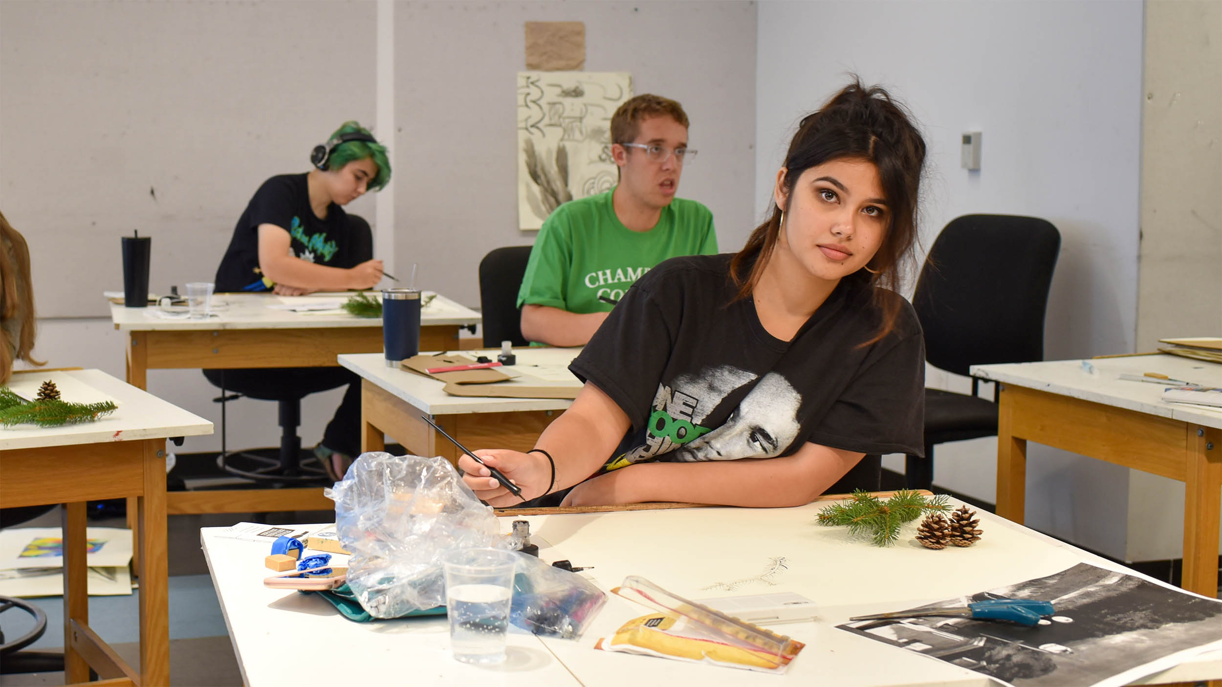 students drawing and painting objects from nature during an art class