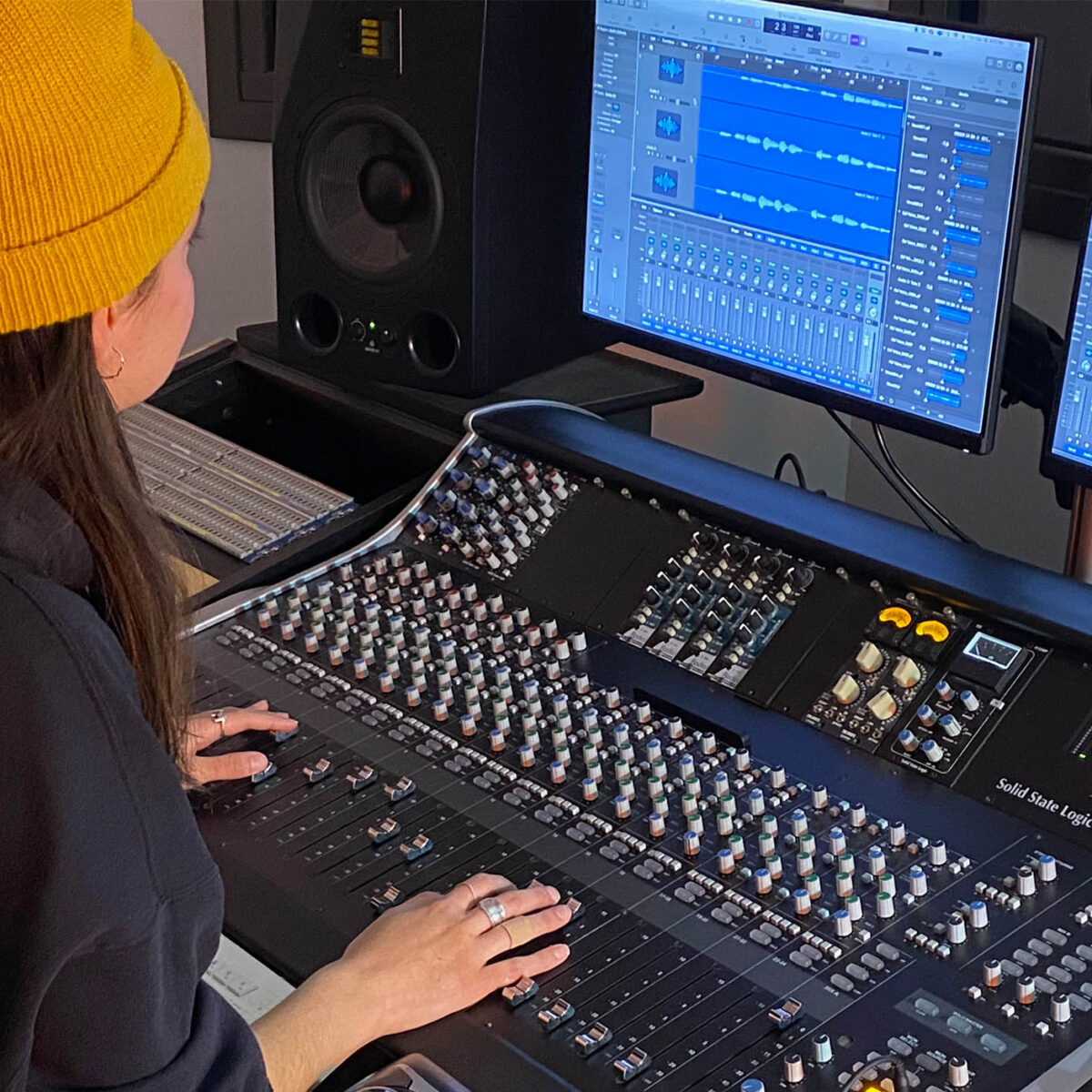 Student mixing audio using professional equipment