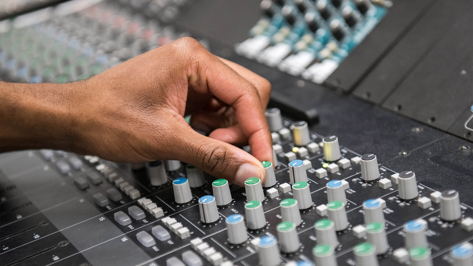 close up photo of hand and sound equipment