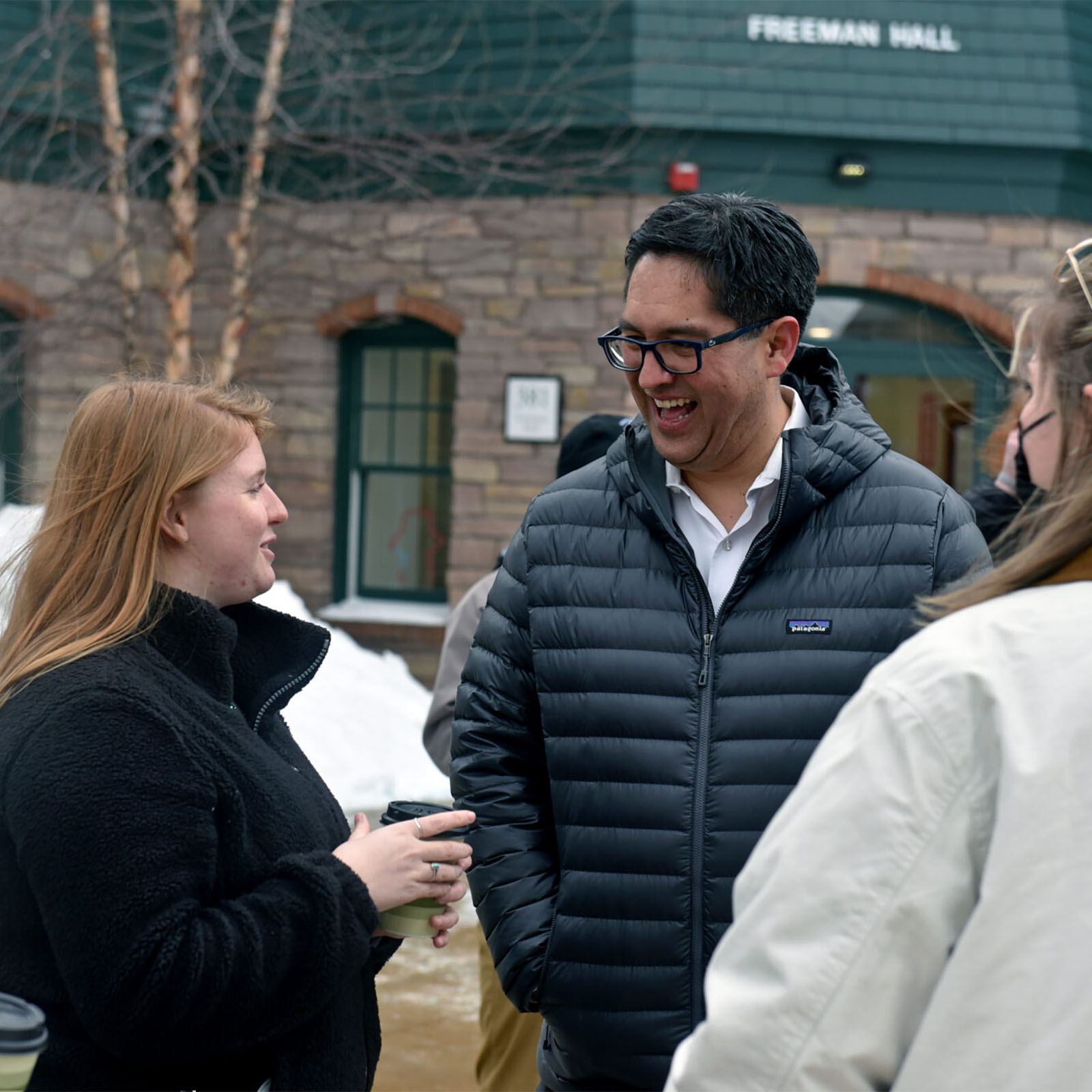 president hernandez laughing with students outside in winter