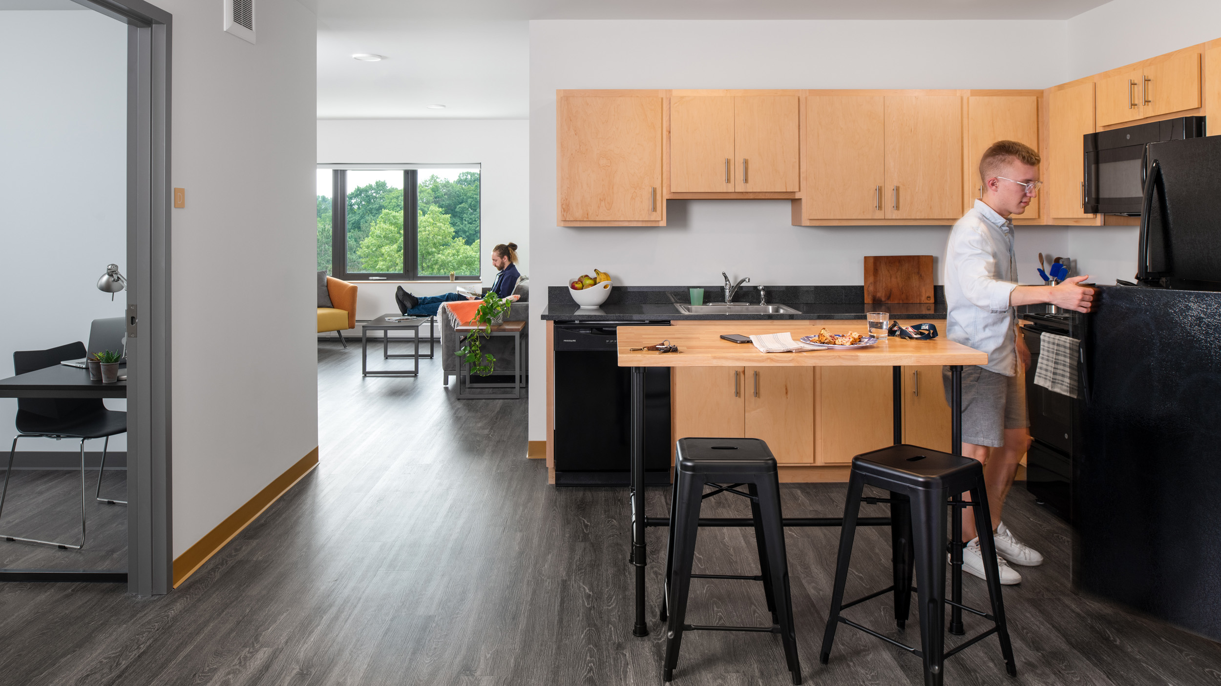 A photo a student using their kitchen in a 194 apartment