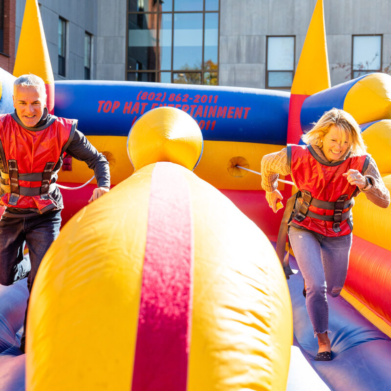 a man and woman race in an inflatable game