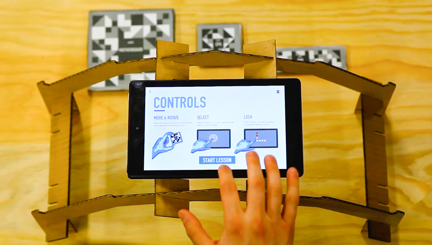 cardboard stand to hold up tablet, hand using tablet