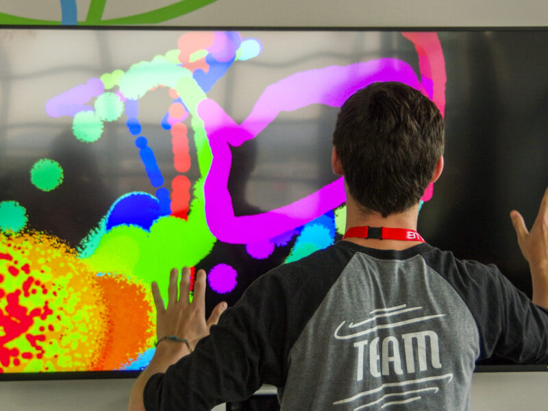 student paints digitally on a tv screen
